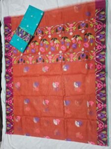 Rust orange Kota Doria saree featuring woven resham floral bootis and a magenta border, paired with a contrasting turquoise teal blouse piece.